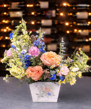 Celebrating You, Mom! floral arrangement with peach roses and soft garden flowers