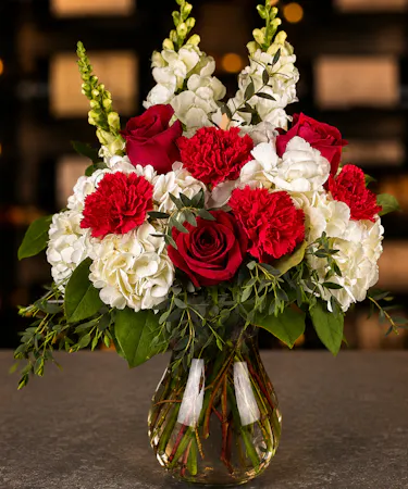 Heart's Desire bouquet with red roses, white hydrangea and snapdragons in an elegant glass vase from the Best Florist in Columbus Ohio.