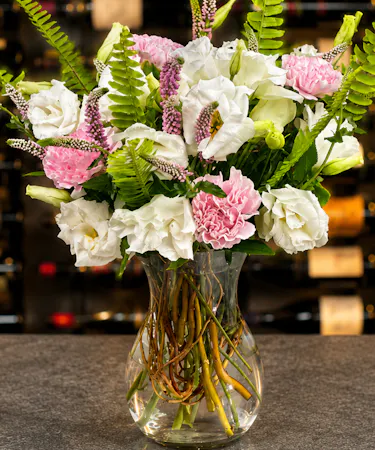 Blush pink carnations and white lisianthus with fern accents in modern glass vase – Columbus Ohio florist