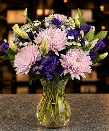 Lavender chrysanthemums and purple lisianthus arranged in clear glass vase – Columbus Ohio florist