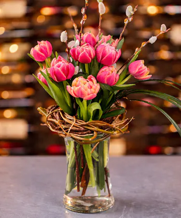 A vibrant bouquet of assorted  colorful tulips in a glass vase. Available for same-day delivery in Columbus, New Albany, and Newark, OH from Griffin’s Floral Design.