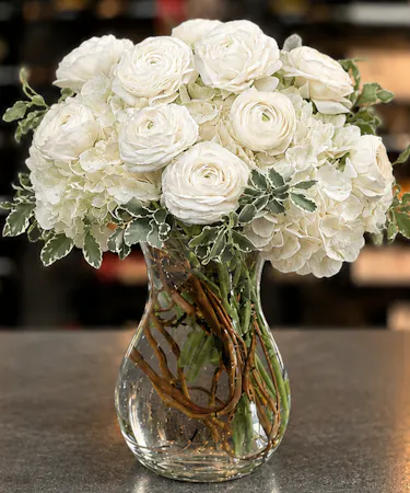 All white ranunculus and hydrangea arranged in modern clear glass vase – Columbus Ohio florist