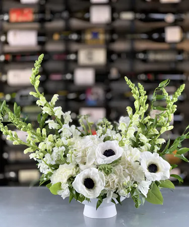 White Meadows Bouquet featuring white snapdragons, aromatic stock, hydrangea, and anemone delivered in Columbus, Ohio.