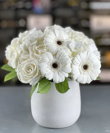 Simple white gerbera daisy and rose arrangement delivered by a Columbus, Ohio florist Griffins Floral